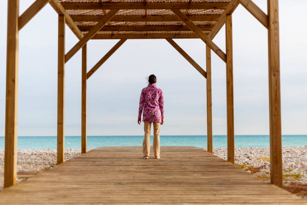 istock A young woman is sitting on a beach 897023076