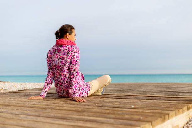 istock A young woman is sitting on a beach 897023502