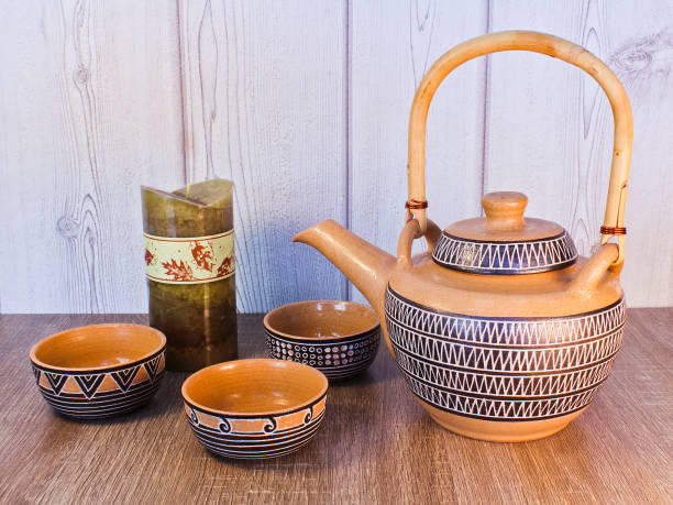 istock Tea set with green candle on wood background 897023602