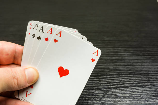istock Four of a kind on the hand with aces. 897031100