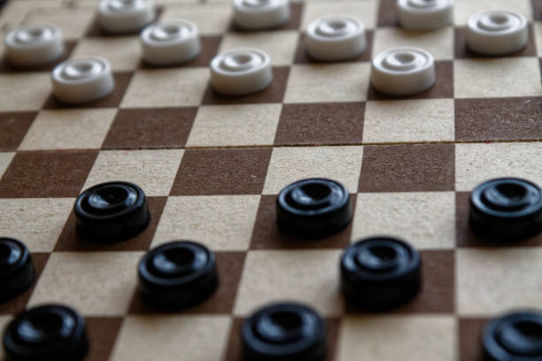 istock Checkers in checkerboard ready for playing. Game concept. Board game. Hobby. checkers on the playing field for a game. 897039246