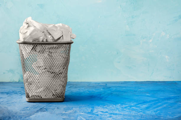 istock A trash can for paper. Beautiful background with place for text. A full trash can for crumpled paper sheets. 897040754