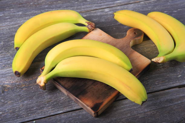 istock Ripe bananas on wooden table 897048362