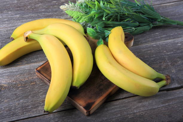 istock Ripe bananas on wooden table 897048580