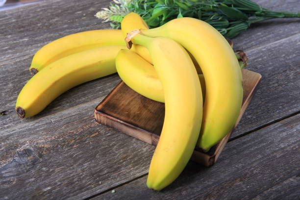 istock Ripe bananas on wooden table 897052830