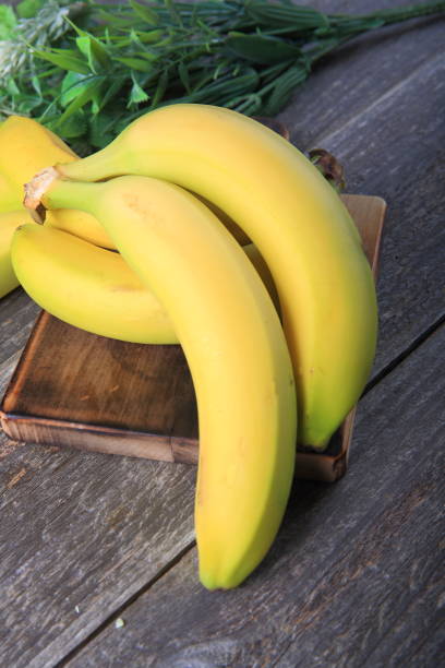 istock Ripe bananas on wooden table 897052926