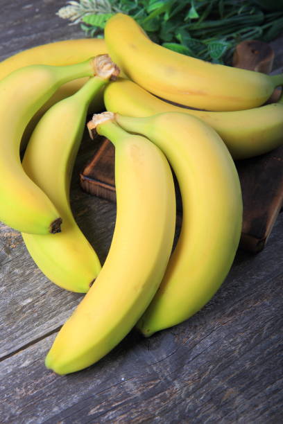 istock Ripe bananas on wooden table 897052996