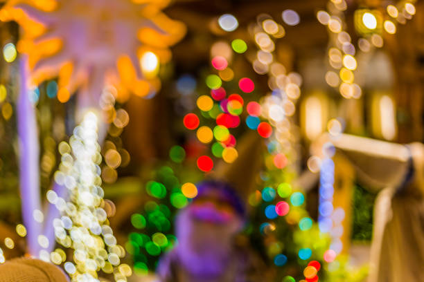 istock Abstract blurred background with christmas tree, holiday decorations, beautiful light bokeh and personages 897053238