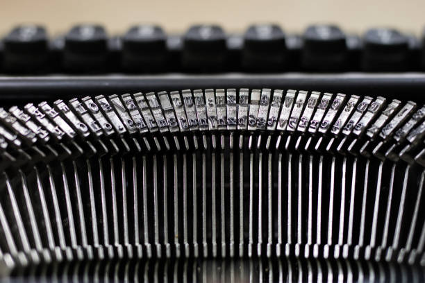 istock Typewriter and white card screwed into the machine. Wooden table with a typewriter. White background. 897059194