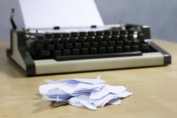 istock Typewriter and white card screwed into the machine. Wooden table with a typewriter. White background. 897060102