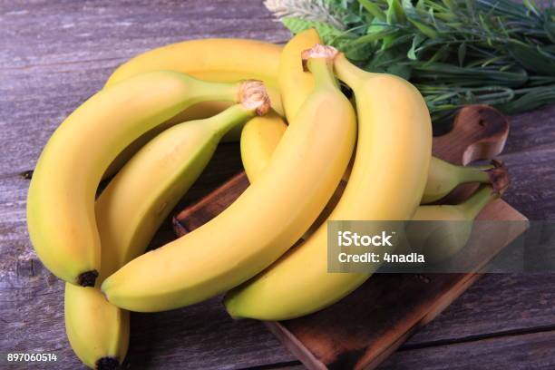 Ripe Bananas On Wooden Table Stock Photo - Download Image Now - Banana, Freshness, Peel - Plant Part