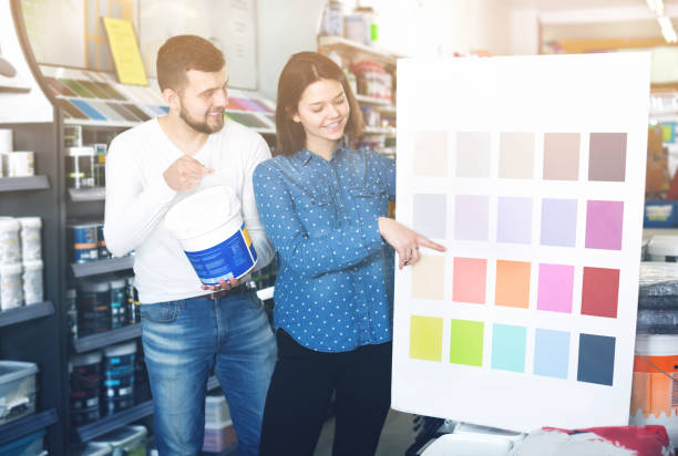 istock Couple deciding on best color scheme 897060602