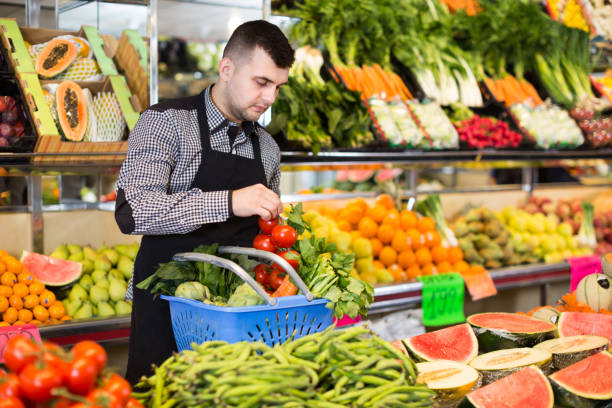 istock Male seller helping to choose 897060606