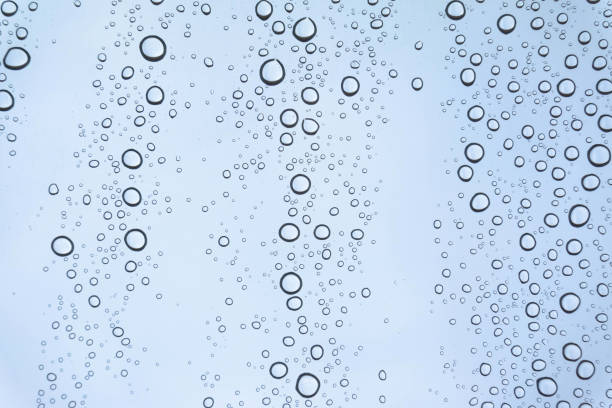 istock Blue Drops water drops on glass surface as background. 897066516