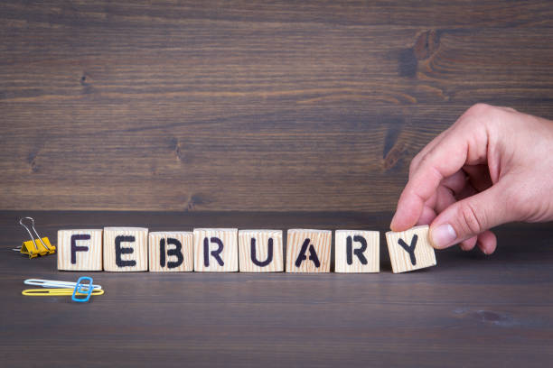istock february. Wooden letters on the office desk, informative and communication background 897070374