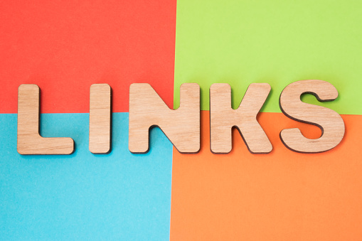 Links in search engine optimization SEO concept photo. 3D letters form word Links means backlinks and hyperlink in web, part of Internet marketing in 4 colors background : blue, green, orange and red