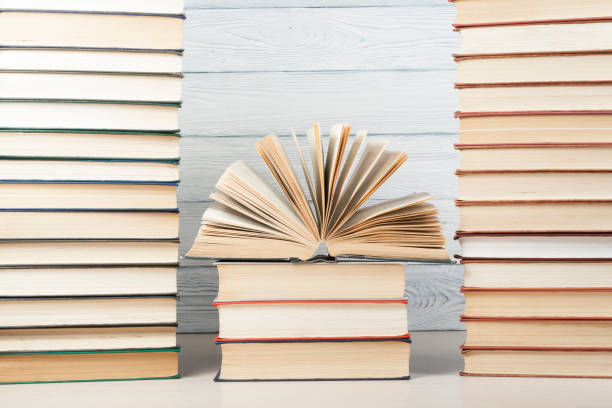 istock Open book, hardback books on wooden table. Education background. Back to school. Copy space for text. 897078126