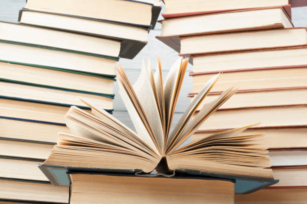 istock Open book, hardback books on wooden table. Education background. Back to school. Copy space for text. 897078224