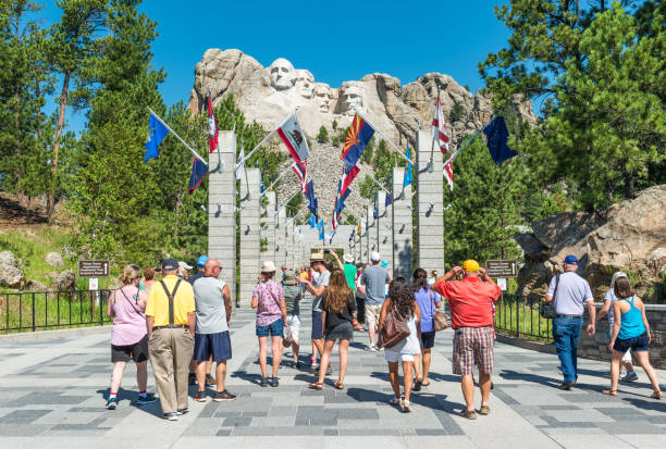 Mount Rushmore National Monument Entrance The Entrance of the Mount Rushmore National Monument on a sunny summer day with tourists and taking photographs of the view, Black Hills National Forest, South Dakota, USA. black hills national forest stock pictures, royalty-free photos & images