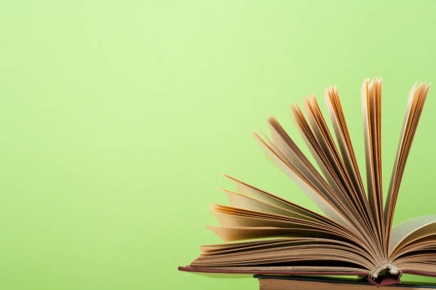 istock Open book, hardback books on wooden table. Education background. Back to school. Copy space for text. 897080680