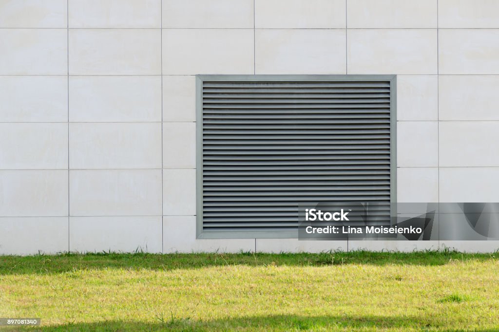 Lattice shutters vent cover on the wall of the house. Air Duct Stock Photo