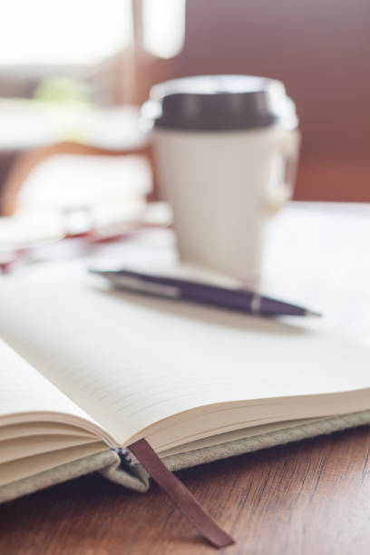 istock Close-Up Of Pen With Open Book On Table 897081588