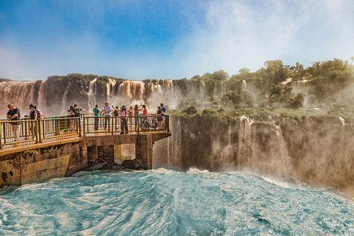 Foz Do Iguacu: People on a footbridge in the middle of the Iguazu waterfalls on the brazilian side.
