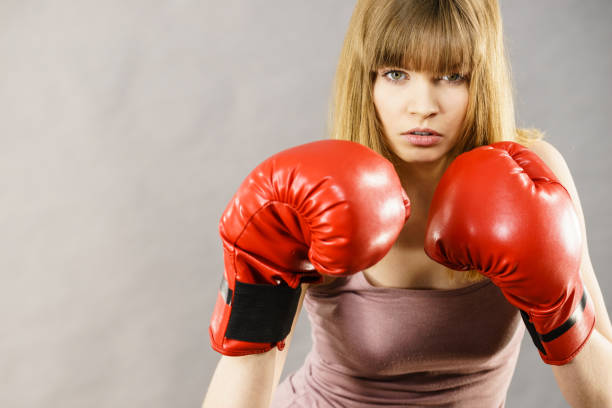 istock Woman wearing boxing gloves 897110180