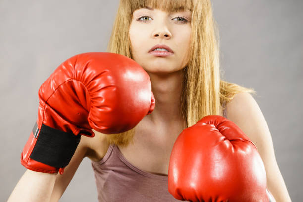 istock Woman wearing boxing gloves 897110430