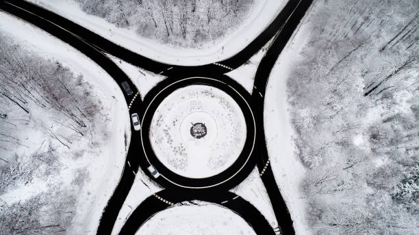 istock Road through wintery forest - aerial view 897125628