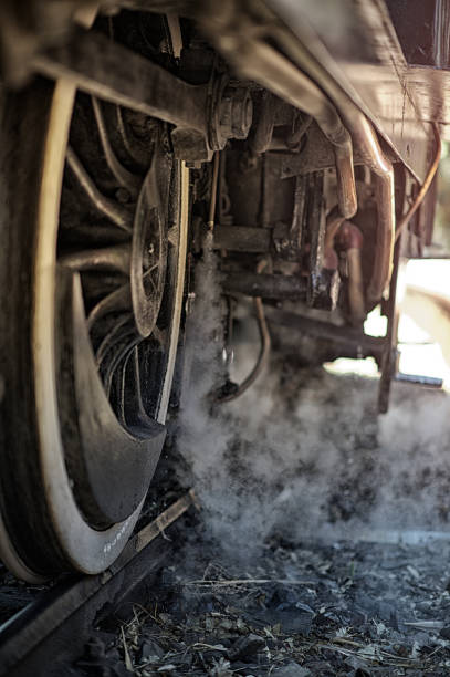 An antique steam train wheels on the track with steam Pretoria South Africa