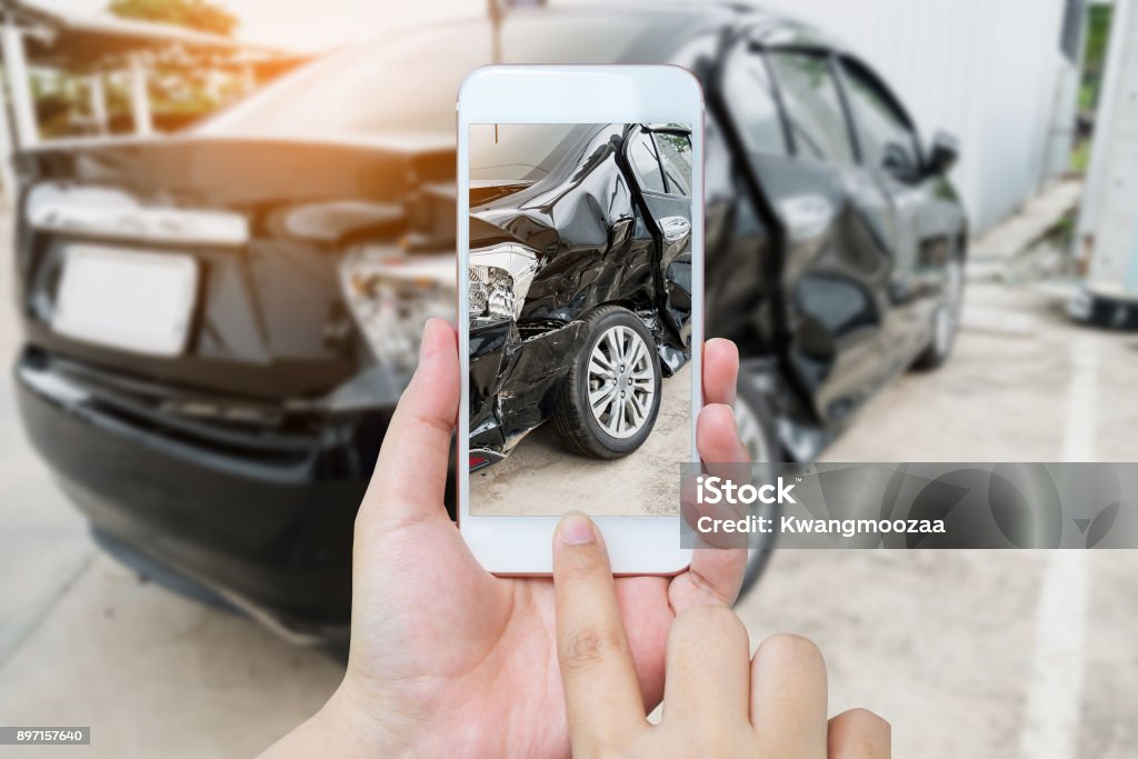 female hold mobile smartphone photographing car accident female hold mobile smartphone photographing car accident for insurance Car Accident Stock Photo