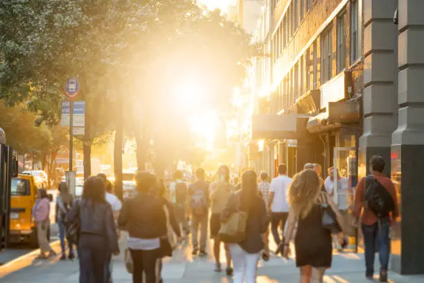 Photo of Crowd of people walking down sidewalk in New York City