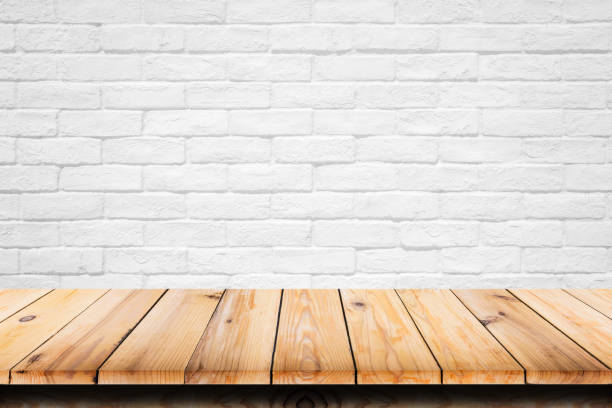 istock Empty top of wooden table on white brick background. 897173394