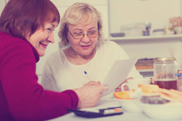 istock females at the table with utilities bills 897173600