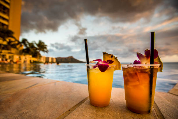 Cocktail drinks on beach at sunset. Hawaiian cocktails on Waikiki beach during sunset. mai tai hawaii stock pictures, royalty-free photos & images