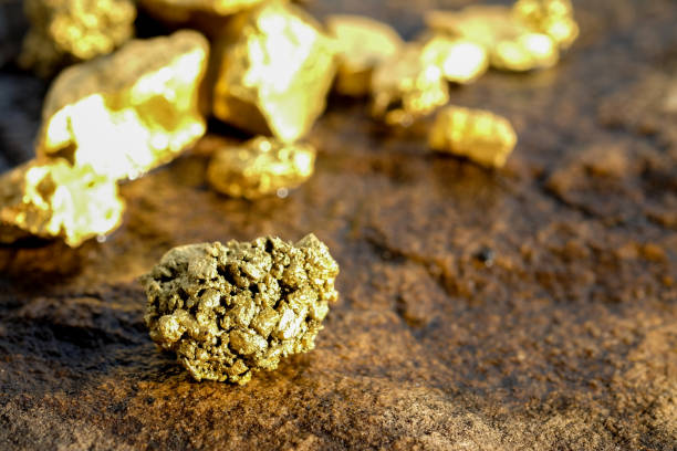 istock The pure gold ore found in the mine on a stone floor 897204304