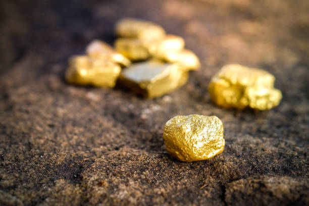 istock The pure gold ore found in the mine on a stone floor 897204306