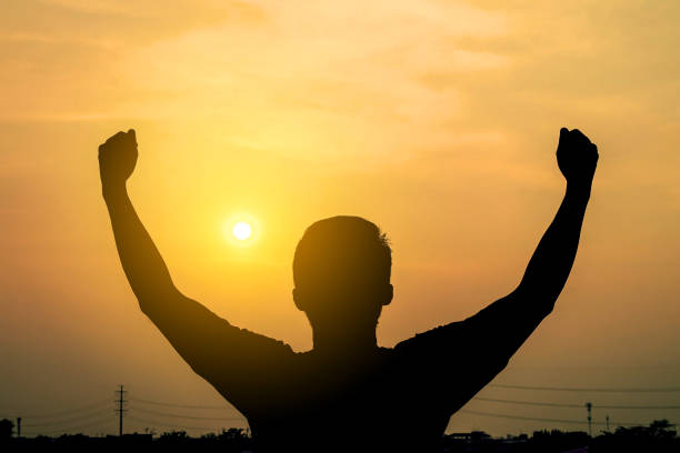 istock silhouette of a man shows with success text on a sunset background. Concept Positive thinking 897204388