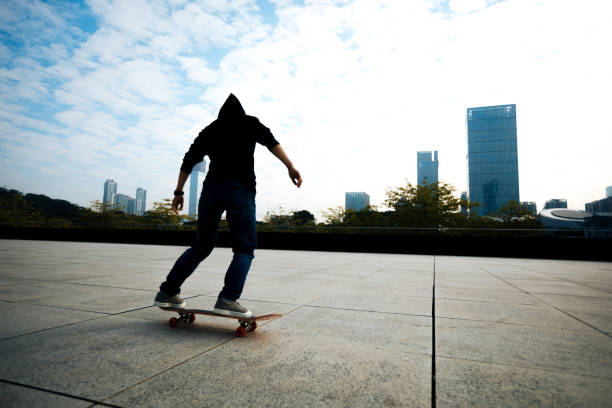 istock female skateboarder riding with skateboard on city 897212694