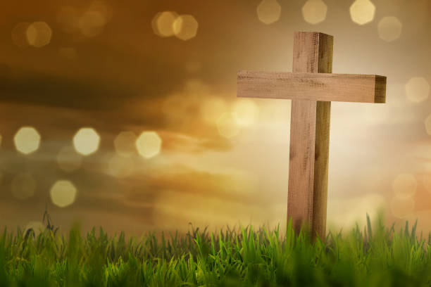 istock Holy cross on the field with green grass 897218540