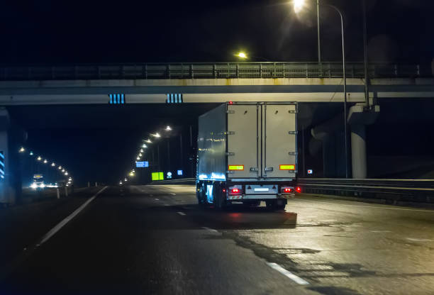 istock truck moves on highway at night 897220600