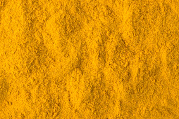 istock turmeric powder spice as a background, natural seasoning texture 897221126