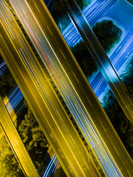 istock Aerial highway junction at night time 897223388