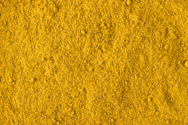 istock curry powder spice as a background, natural seasoning texture 897223890