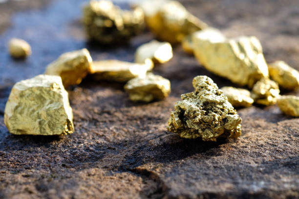 istock The pure gold ore found in the mine on a stone floor 897227092