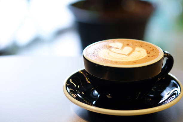 istock Hot coffee on a wooden table with selective focus, macro closeup 897227100