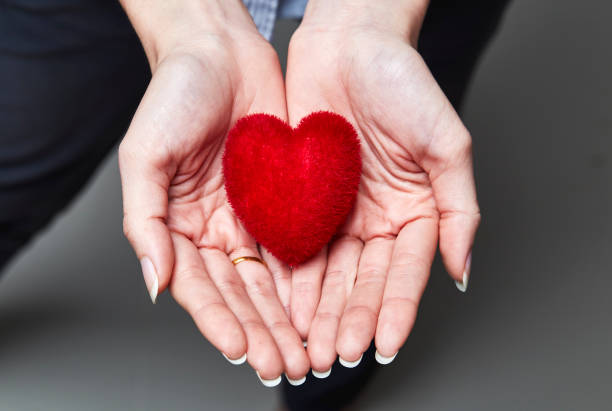 istock Red sweet heart in woman's hands 897232908