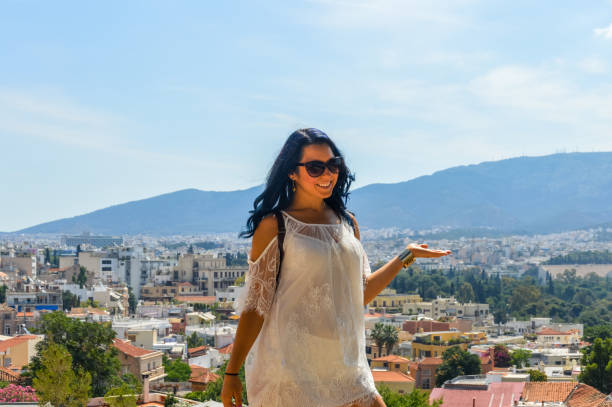 istock Young attractive woman with Ancient Greece background 897235638