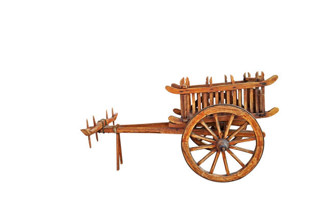 Rural vintage landscape. Wooden cart with straw in the foreground against the background of an old wooden mill and a green forest.